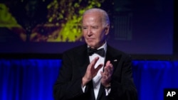 US President Joe Biden applauds at the conclusion of the White House Correspondents' Association Dinner at the Washington Hilton, April 27, 2024, in Washington. 