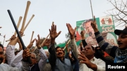 Supporters of former Pakistani Prime Minister Imran Khan chant slogans, after police postpone the arrest of Khan, outside his home in Lahore, Pakistan, March 15, 2023. 