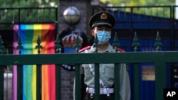 A Chinese paramilitary policeman stands guard outside the Swedish Embassy during Diversity Week in Beijing, May 12, 2023. On May 15, 2023, the advocacy group know as the Beijing LGBT Center became the latest organization to close under a government crackdown.