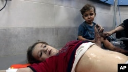 Wounded Palestinian children receive treatment at the al-Shifa hospital, following Israeli airstrikes on Gaza City, Oct. 26, 2023.