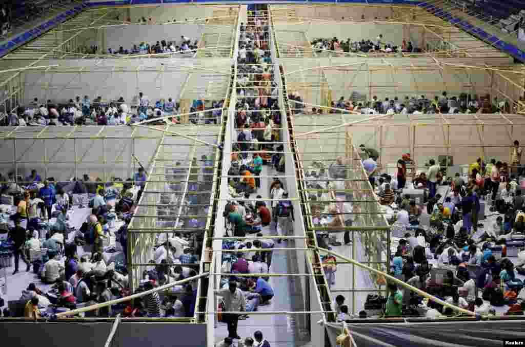 Polling officials check election materials inside an indoor stadium ahead of the seventh and last phase of India's general election, in Kolkata, India.