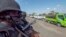 FILE - In this image made from video, police patrol a road in Palma, Cabo Delgado province, Mozambique, Aug. 15, 2021. The United Nations says jihadist violence in the region has forced more than a million people to flee their homes. 