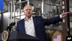 FILE - Gov. Tim Walz, D-Minn., speaks before President Joe Biden at the Earth Rider Brewery, Jan. 25, 2024, in Superior, Wisconsin. U.S. media reports say, Aug. 6, 2024, Vice President Kamala Harris has selected him as her running mate.