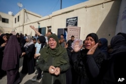 Palestinians mourn the loss of their relatives who were killed in an Israeli airstrike in Nuseirat, at the Al Aqsa Hospital in Deir al-Balah, Gaza Strip, May 19, 2024.