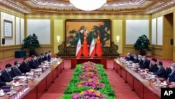 FILE - Chinese President Xi Jinping, fourth from left, talks to visiting Iranian President Ebrahim Raisi, third from right, during a bilateral meeting at the Great Hall of the People in Beijing, Feb. 14, 2023. (Xinhua via AP)