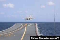 A J-15 Chinese fighter jet takes off from the Shandong aircraft carrier during the combat readiness patrol and military exercises around the Taiwan Island, April 9, 2023.