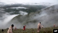 Rescue team members search for the wreckage of the helicopter carrying Iranian President Ebrahim Raisi after it crashed in Varzaghan in northwestern Iran, on May 20, 2024. (Azin Haghighi/Moj News Agency/via AP)