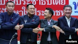 Bhumjaithai Party leader Anutin Charnvirakul (2-L) and Pheu Thai Party leader Chonlanan Srikaew (2-R) shake hands after a press conference about forming an alliance between Pheu Thai and Bhumjaithai party, in Bangkok, Thailand, Aug. 7, 2023.