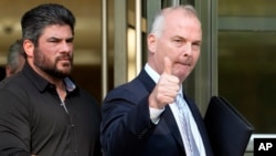 FILE - Michael McMahon, right, gives photographers a thumbs up as he leaves federal court, May 31, 2023, in the Brooklyn borough of New York.