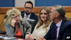 Jenna Ellis reacts with her lawyers after reading a statement inside Fulton Superior Court Judge Scott McAfee's Fulton County Courtroom, Oct. 24, 2023, in Atlanta. 