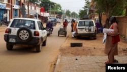 A man stands on a sidewalk, as vehicles move on a street in Niamey, Niger, Aug. 2, 2023. Niger is a key US partner in fighting Islamic extremism in the Sahel.