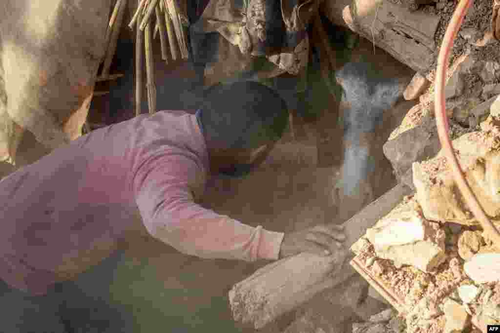 A man rescues a donkey trapped under rubble after an earthquake in the mountain village of Tafeghaghte, southwest of the city of Marrakesh, Morocco, on Sept. 9, 2023. 