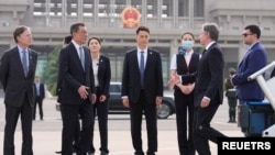 U.S. Secretary of State Antony Blinken is welcomed by Yang Tao, Director General of the Department of North American and Oceanian Affairs of the Foreign Ministry, at the Beijing Capital International Airport in Beijing, April 25, 2024.