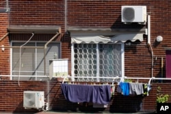 Air conditioning external units are seen on the facade of a building in Rome, July 25, 2023.