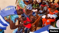 A nurse administers a malaria vaccine to an infant at the health center in Datcheka, Cameroon January 22, 2024. (REUTERS/Desire Danga Essigue)