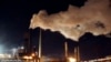 FILE - Steam bellows from a chimney stack at BlueScope Steel's steelworks at Port Kembla, south of Sydney, Australia. 