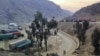 FILE - Trucks loaded with goods are seen parked at border crossing point Torkham in Afghanistan's eastern Nangarhar province, on the country's border with Pakistan, Feb. 21, 2023.