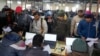 FILE - Indian workers to be hired for jobs in Israel submit their forms during a recruitment drive in Lucknow, India, Jan. 25, 2024. In the event of a war in the Middle East, Indian workers will be the most affected and remittances will stop.