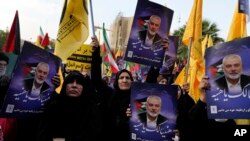 Iranian protesters attend a rally condemning the killing of Ismail Haniyeh as they hold posters of the Hamas leader, in Tehran, Iran, July 31, 2024.