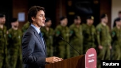 FILE - Canada's Prime Minister Justin Trudeau announces that Canada will send more military equipment and impose additional sanctions on Russian officials on the one-year anniversary of Russia's invasion of Ukraine, at Fort York Armoury in Toronto, Canada, Feb. 24, 2023.