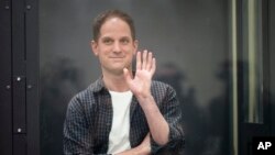 FILE - Wall Street Journal reporter Evan Gershkovich stands in a glass cage in a courtroom at the First Appeals Court of General Jurisdiction in Moscow, Russia, April 23, 2024.