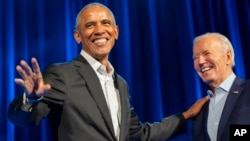 President Joe Biden, right, and former President Barack Obama participate in a fundraising event with Stephen Colbert at Radio City Music Hall in New York, March 28, 2024.