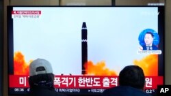 A TV screen shows a file image of North Korea's missile launch during a news program at the Seoul Railway Station in Seoul, South Korea, Feb. 20, 2023. 