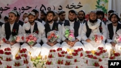 Afghan grooms look on during a mass wedding ceremony at a wedding hall in Kabul, Dec. 25, 2023. 