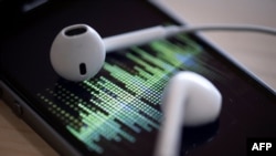 FILE - An audio podcast is being played on a smartphone in Paris, France, Feb. 8, 2019. As people brace for the disruptive impact of artificial intelligence on jobs and everyday living, those in the world of audio books say their field is already being transformed.