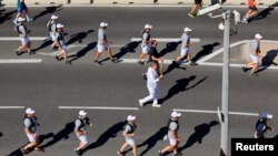 A torchbearer carries the flame during the relay ahead of the 2024 Paris Olympic Games, in Marseille, France, May 9, 2024. 
