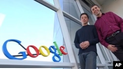 FILE - Google co-founders Sergey Brin, left, and Larry Page pose at company headquarters in Mountain View, California, Jan. 15, 2004.