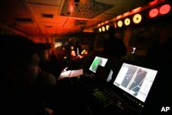 Philippine coast guard personnel on board the BRP Malabrigo monitor a Chinese Navy war ship near Subi, one of seven barren reefs, which China has transformed in the last decade into missile-protected island base at the South China Sea, April 22, 2023.