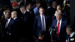 FILE - Republican presidential candidate former President Donald Trump, right, surrounded by members of the Secret Service, is seen arriving to attend the final night of the Republican National Convention in Milwaukee, Wisconsin, July 18, 2024.