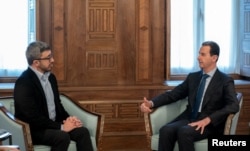 FILE - Syria's President Bashar al-Assad, right, meets with UAE Foreign Minister Sheikh Abdullah bin Zayed bin Sultan al-Nahyan, in Damascus, Syria, Feb. 12, 2023. (Syrian Presidency/Handout via Reuters)