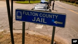 A Fulton County Jail signs points to where the jail is located, Aug. 24, 2023, in Atlanta. 