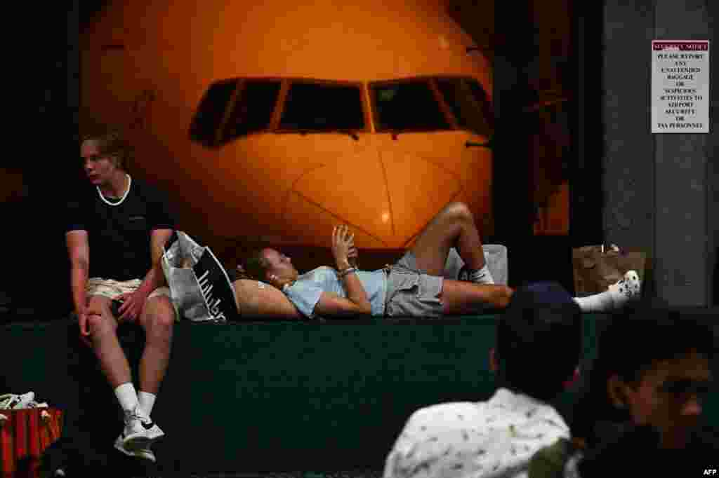 Passengers wait for delayed and canceled flights off the island as thousands of passengers were stranded at the Kahului Airport in the aftermath of wildfires in western Maui in Kahului, Hawaii on Aug. 9, 2023.
