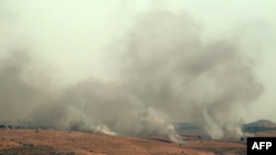 FILE - Smoke billows over hills in the Israeli-annexed Golan Heights after rockets were fired from the Lebanese side of the border, July 3, 2024.