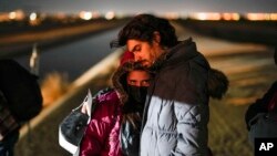 FILE - A couple from Cuba wait to be processed to seek asylum after crossing the border into the United States, Jan. 6, 2023, near Yuma, Ariz.