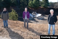 Anže Slosar, Sven Herrmann, and Paul O'Connor (pictured left to right) stand in front of BMX, the prototype radio telescope that was developed at Brookhaven. (Image Credit: Brookhaven National Laboratory)