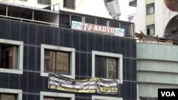 FILE - The sign of Turkey’s first Kurdish-language media outlet, Can Radio and TV, is seen in the heavily damaged Galleria Apartment Complex in Diyarbakir. (Photo: Mahmut Bozarslan/Diyarbakir)