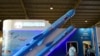 FILE - Visitors walk past a model of India's Brahmos supersonic cruise missile displayed at the Defence Expo 2022 in Gandhinagar on Oct. 18, 2022. 
