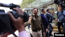 Police officers stand outside a building housing BBC offices as tax officials conduct a search of the premises, in New Delhi, India, Feb. 14, 2023. 