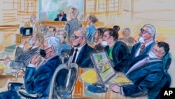 FILE - This sketch depicts the trial of five Oath Keepers in the Jan. 6, 2021, Capitol attack, in Washington, Oct. 6, 2022. Jessica Watkins, third from right, and Kenneth Harrelson, right, were sentenced to prison terms May 26, 2023.