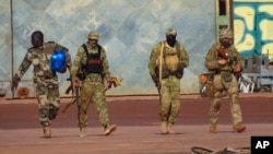 FILE - This undated photo from the French military shows three Russian mercenaries, right, in Mali. Russia's Wagner Group, a private military company, has played a key role in Ukraine fighting and also deployed personnel to the Middle East and Africa.