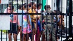 Migrants prepare to depart the US Customs and Border Protection - Marathon Border Patrol Station in Marathon, Fla., on June 26, 2024. 