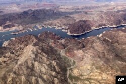 A bathtub ring shows where the water mark on Lake Mead once was along the boarder of Nevada and Arizona, March 6, 2023, near Boulder City, Nev. (AP Photo/John Locher, File)