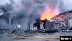 FILE - Firefighters work at the site of storage facilities hit by a Russian missile strike in Dnipro, Ukraine, April 28, 2023. Serhiy Lysak, the regional governor of Dnipropetrovsk, said falling debris from the intercepts caused a fire at a private firm in Dnipro on Tuesday.