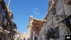 FILE - An Egyptian traditional 'Baladi' flatbread vendor rides his bicycle outside a bakery, in the Old Cairo district of Cairo, Feb. 11, 2023. Egypt’s annual inflation rate reached a record high in July, as price hikes continue. unabated. 