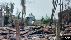 FILE - A destroyed house and burned trees are seen following fighting between Myanmar's military and the Arakan Army ethnic minority armed group in a village in Minbya Township in western Rakhine State, May 21, 2024.