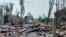 FILE - A destroyed house and burned trees are seen following fighting between Myanmar's military and the Arakan Army ethnic minority armed group in a village in Minbya Township in western Rakhine State, May 21, 2024.